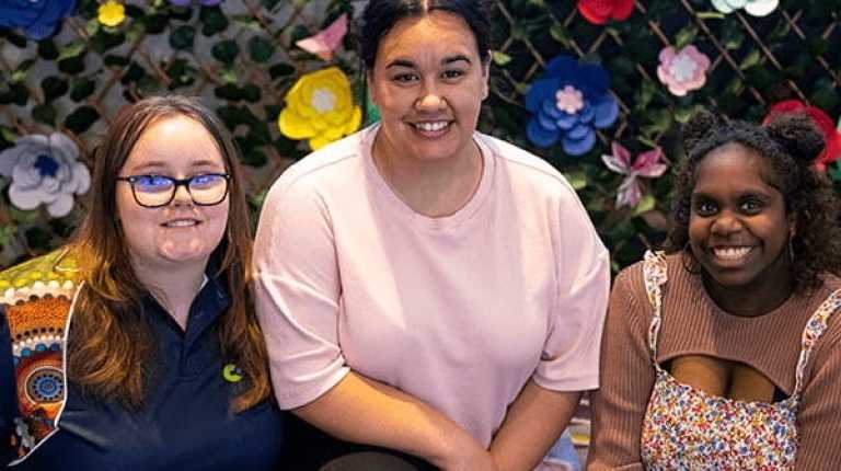 three young women smiling 