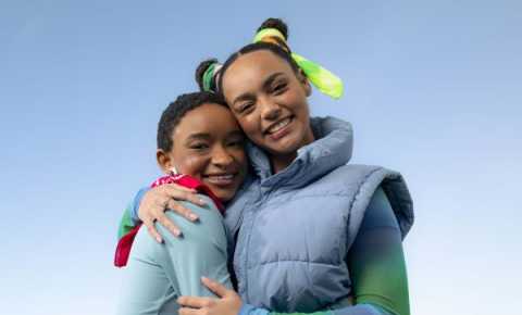 two young people wearing bandannas and embracing