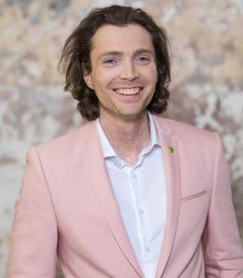 joey lynch who is the chair of the board smiling at the camera and wearing a canteen bandanna on her arm
