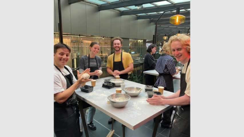 four young people making pizza dough